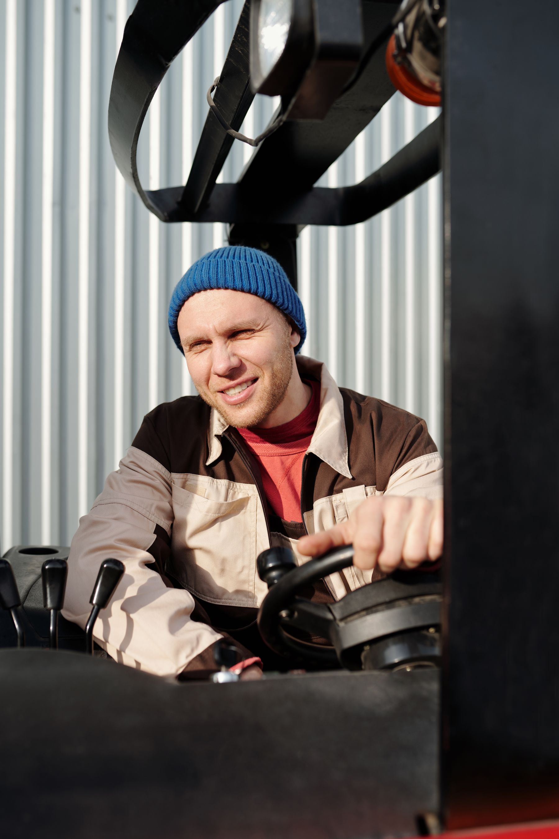 Forklift operator at the controls of warehouse equipment